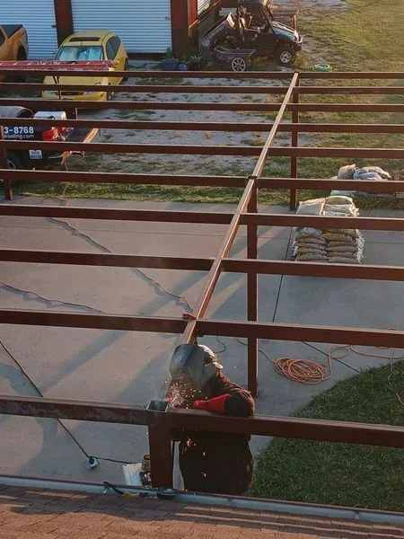 Welded metal gate with horizontal and vertical steel tubing on ranch property
