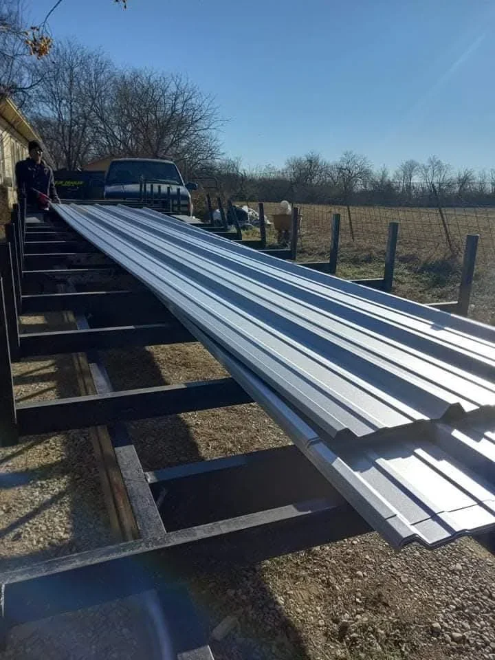 Corrugated metal roofing panels staged on truck bed for installation