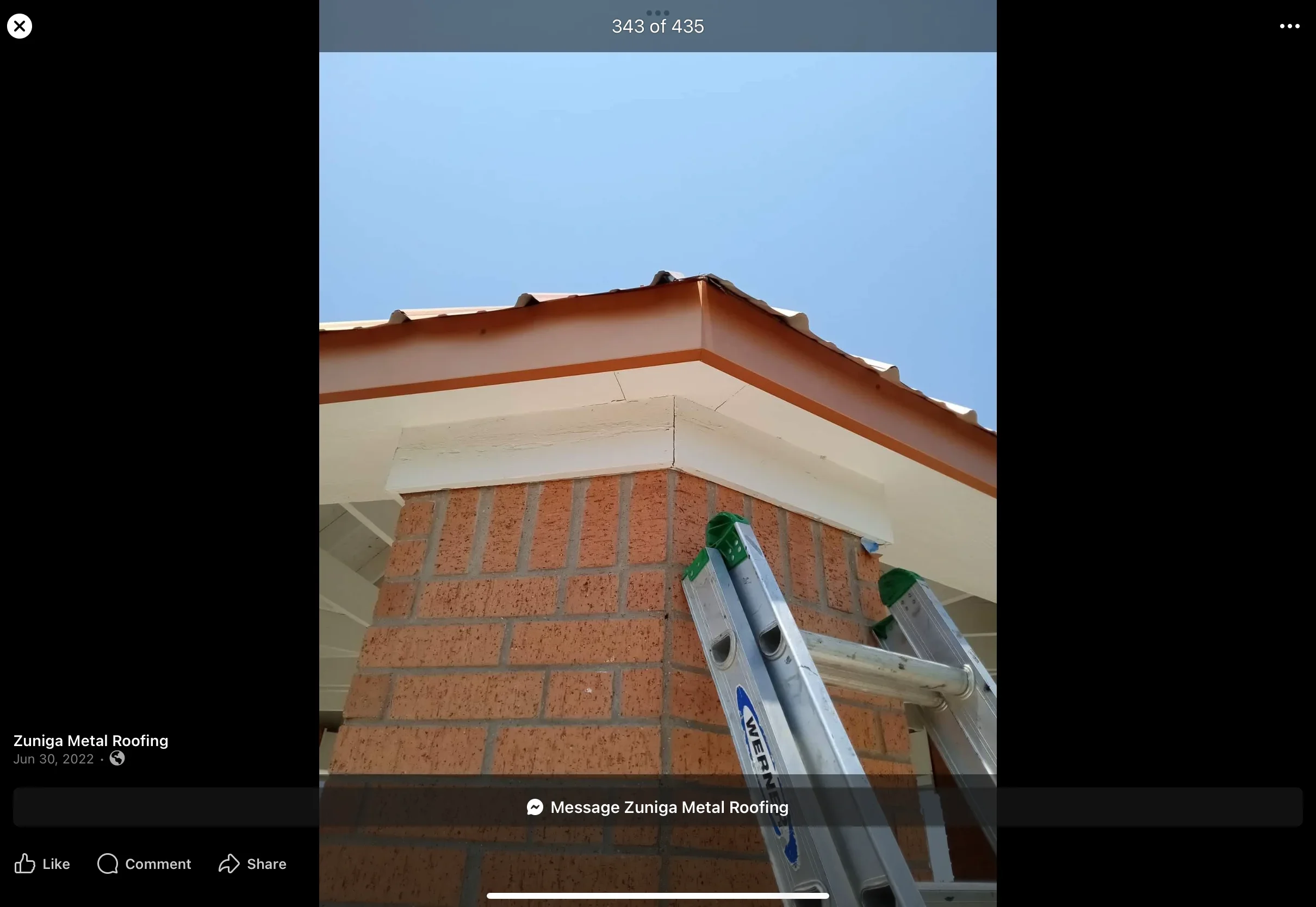 Copper metal roof with standing seam panels, ridge caps, and integrated guttering on brick chimney