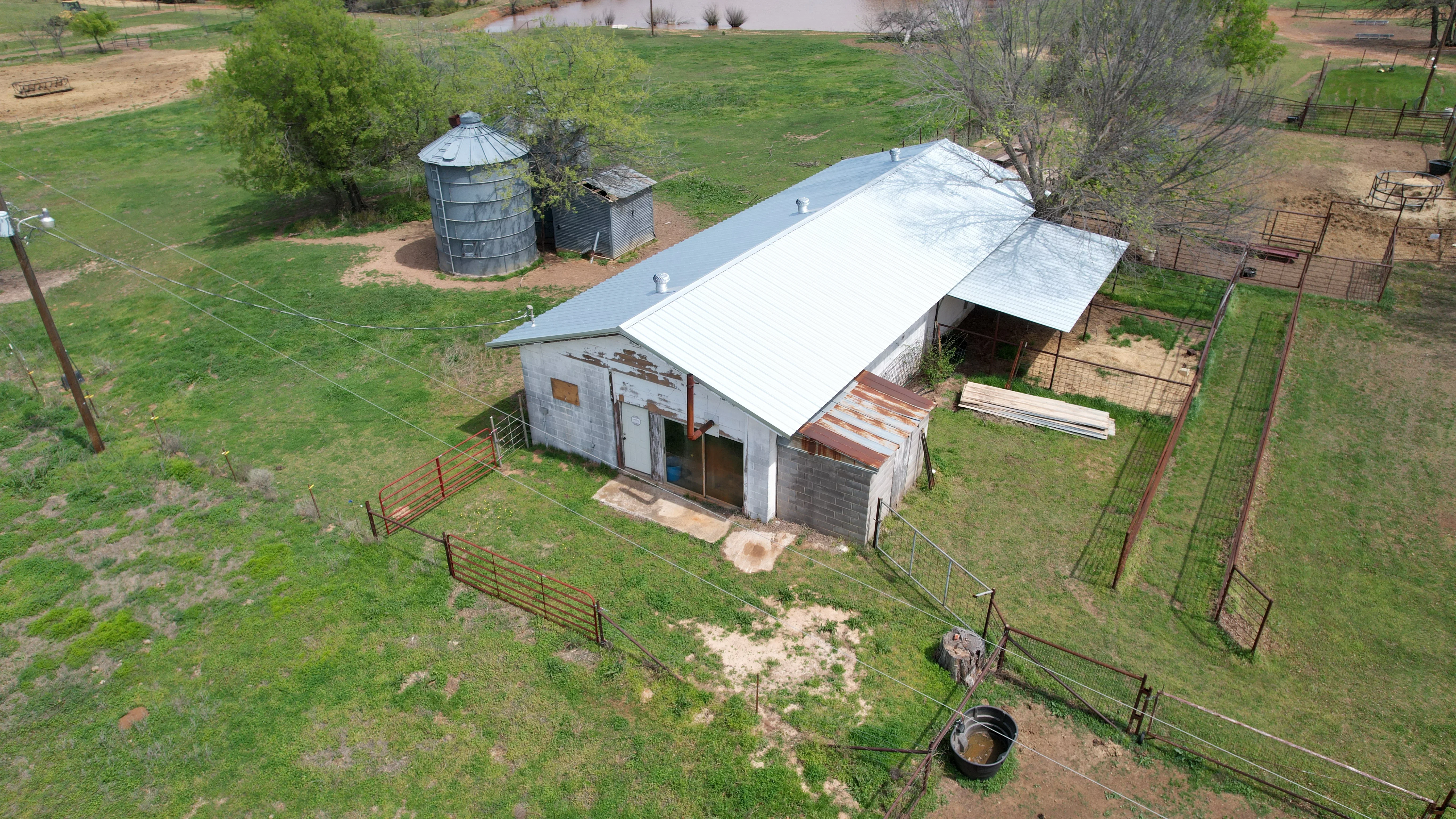 White standing seam metal roof on agricultural barn with concrete block walls
