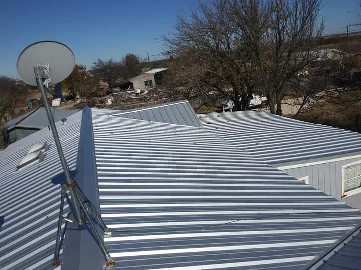 Corrugated metal roof with white and gray panels, clean seams, residential installation