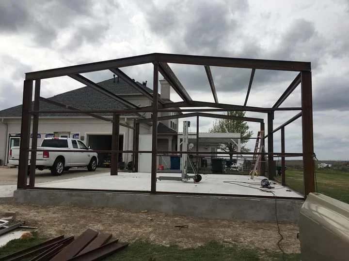 Metal carport frame with polycarbonate panels and steel beam construction