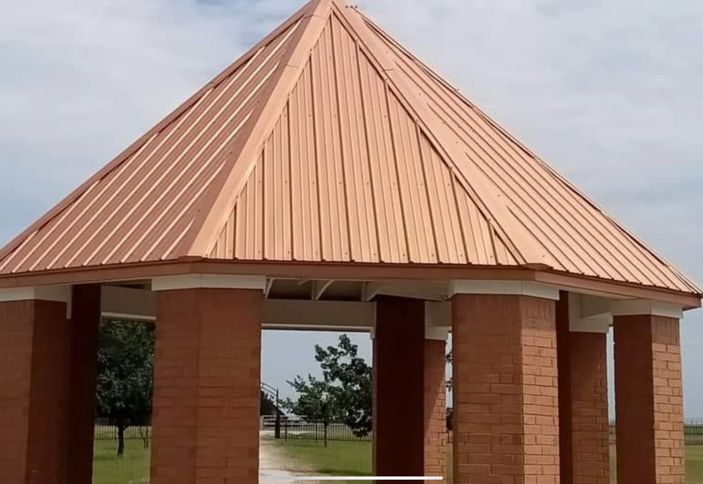 Standing seam copper metal roof on brick pavilion with conical peak design