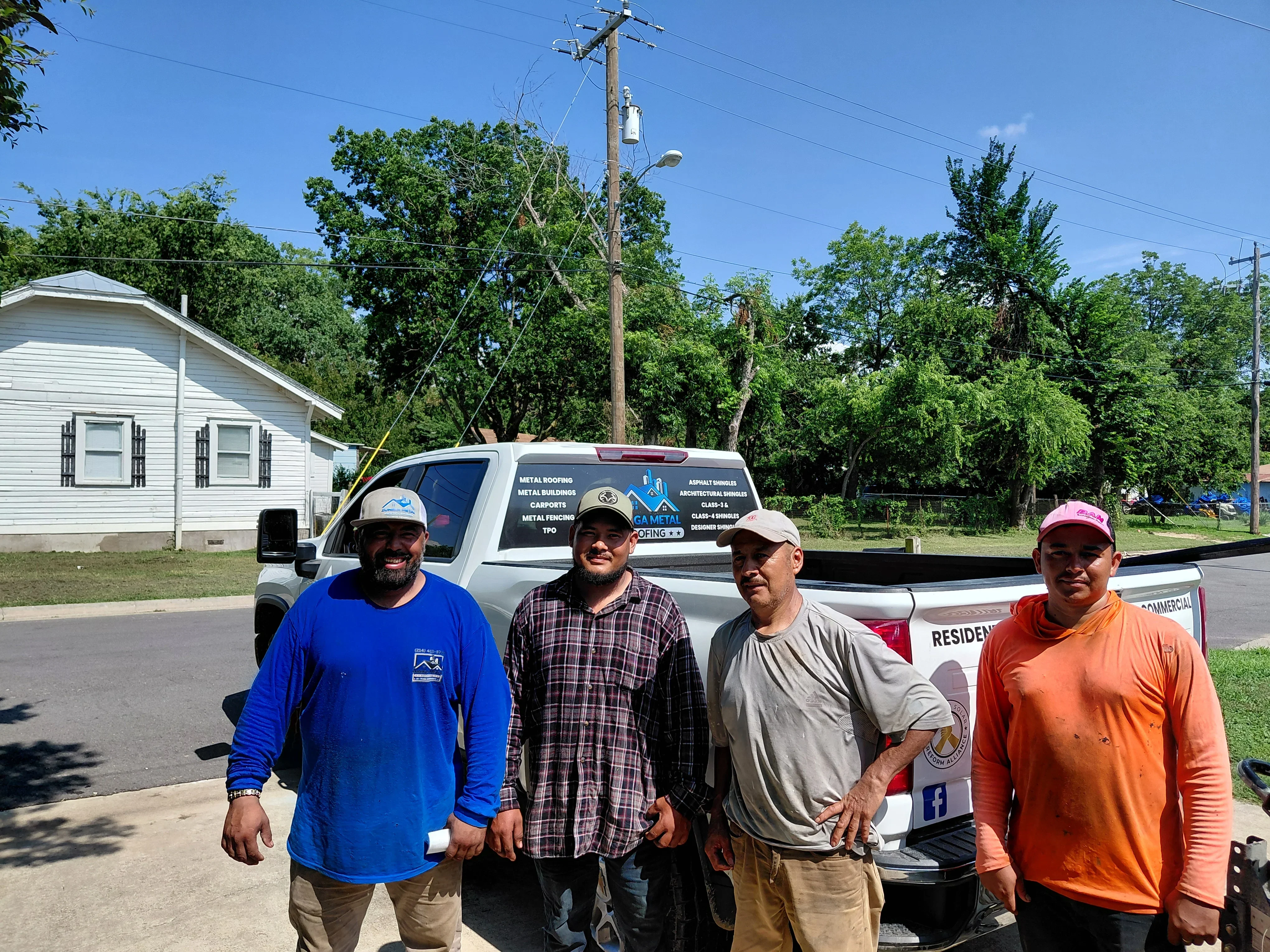 Metal roofing contractor team with service truck displaying metal roofing and building services